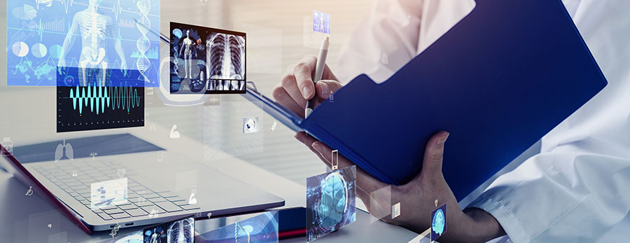 Image of woman holding a folder in front of a laptop, representing a modern as well as futuristic approach to healthcare